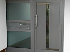 Haustür in grau mit Glas-Seitenteil mit Briefkasten- und Klingelanlage