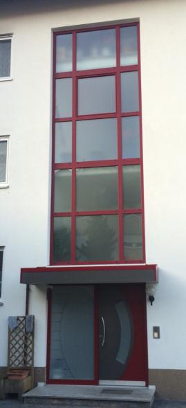 Fenster aus Milchglas mit rotem Rahmen und Haustür mit Milchglas und Milchglas-Seitenteil 